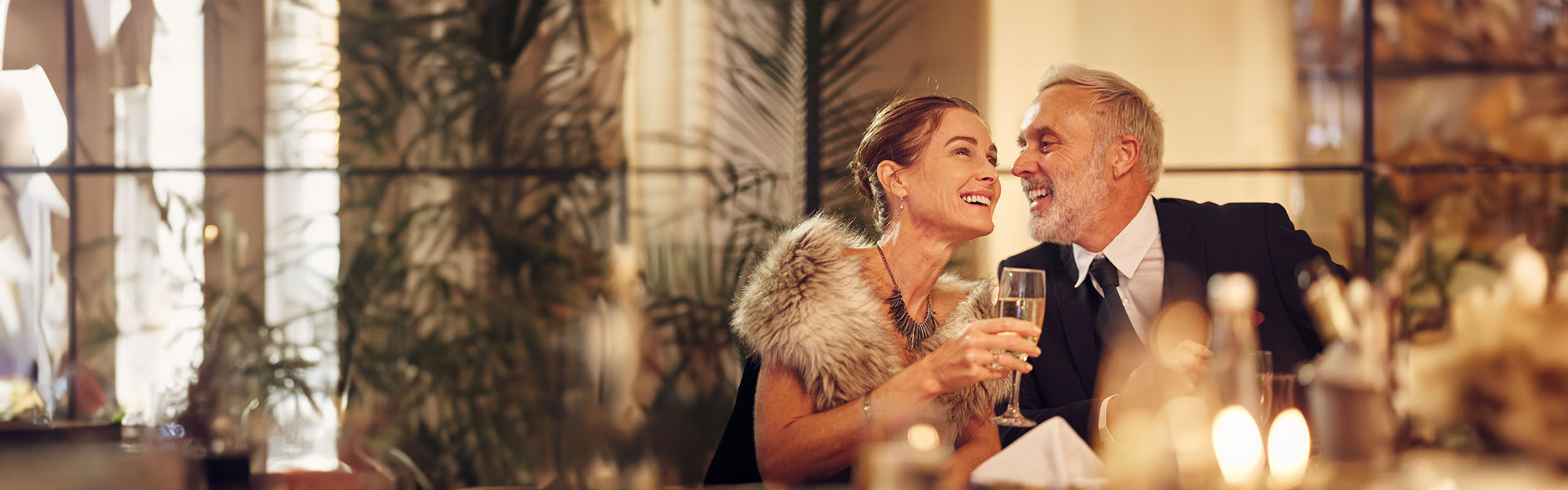 Happy senior couple celebration dinner with wine glass
